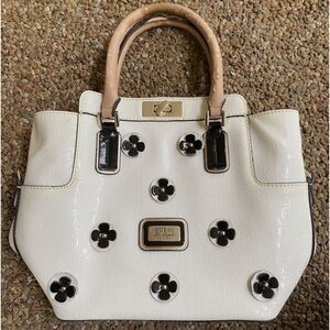 Guess purse cream w black flowers useful but well loved $49